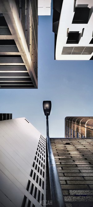 Low angle shot of a lamppost and modern buildings