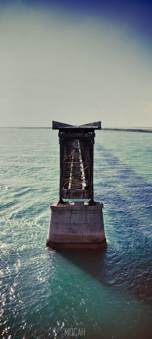 Old bridge ruins over the sea