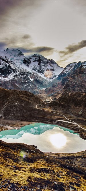 Snow-capped mountains reflected in a turquoise lake