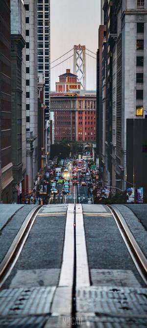 San Francisco street with cable car tracks and Bay Bridge