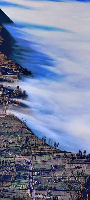 Foggy mountain village with terraced fields