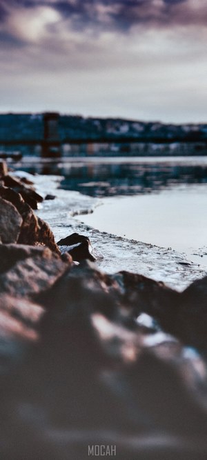 Winter riverbank with rocks and ice
