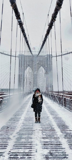 Woman on Brooklyn Bridge in Winter