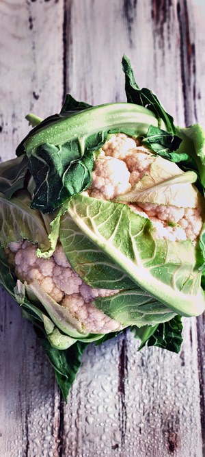 Cauliflower on a wet wooden surface