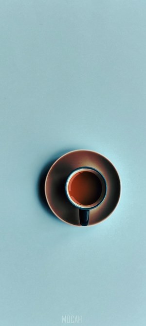Overhead shot of coffee in a blue cup on a saucer