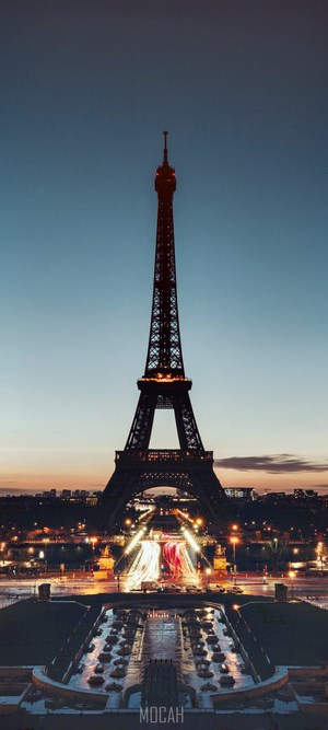 Eiffel Tower at night with city lights and fountain