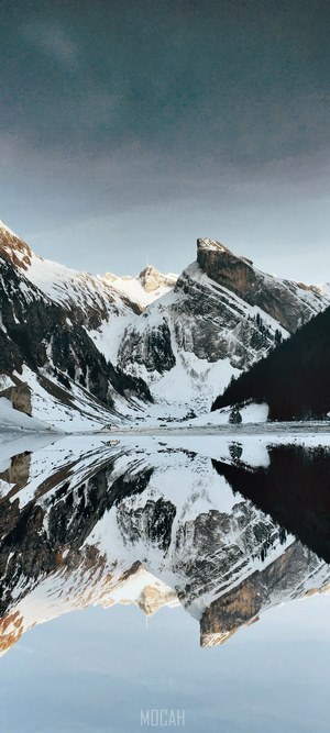 Snowy mountains reflected in a lake in Appenzell Innerrhoden, Switzerland