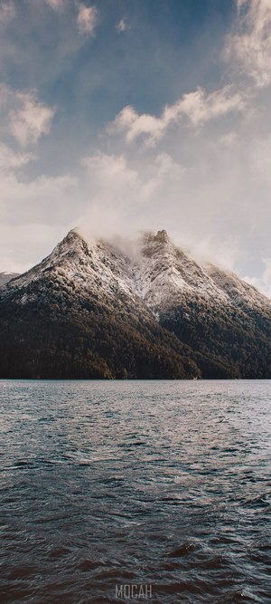 Snow-capped mountain overlooking a lake