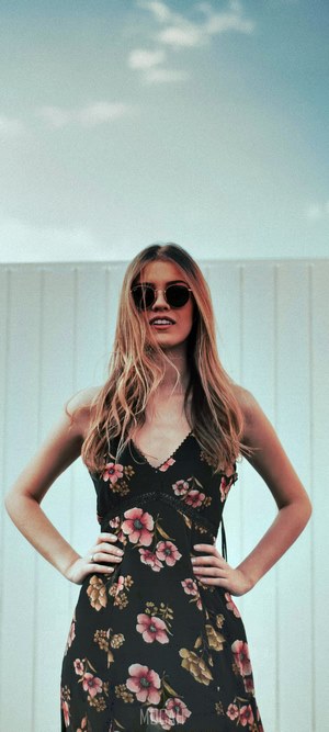 Woman in floral dress and sunglasses