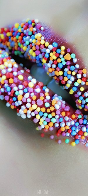 Lips covered in colorful candy sprinkles