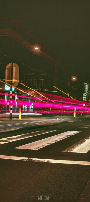 Night street with light trails and crosswalk