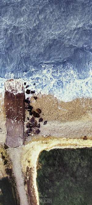 Aerial view of a rocky beach and ocean waves