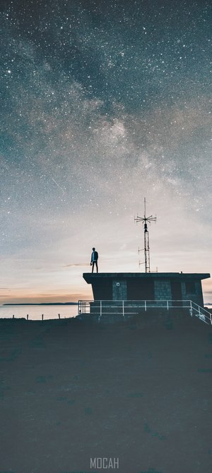 Man on roof under starry sky