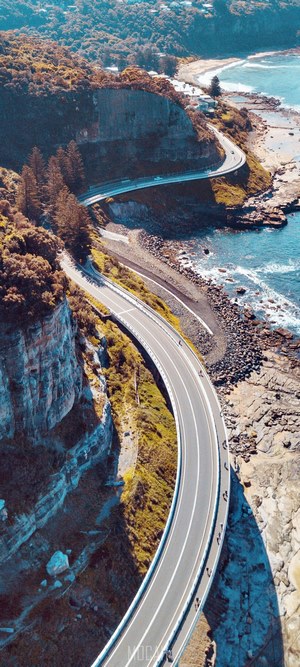 Scenic Cliffside Bridge Over Turquoise Sea