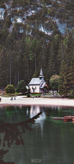 Chapel by a lake in a forest