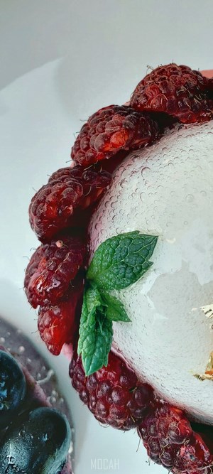Dessert with raspberries, blueberries, and mint