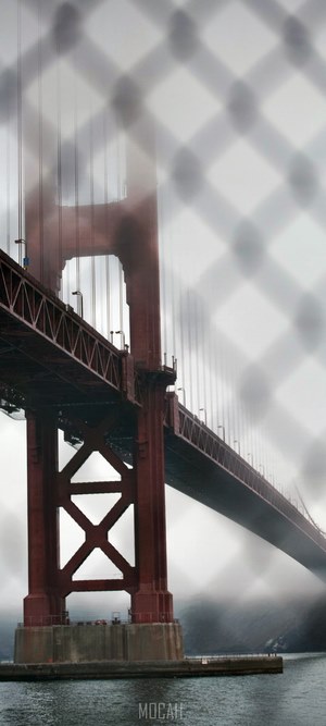 Golden Gate Bridge through a fence