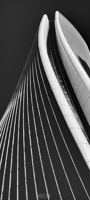 Curved skyscraper facade against a dark sky