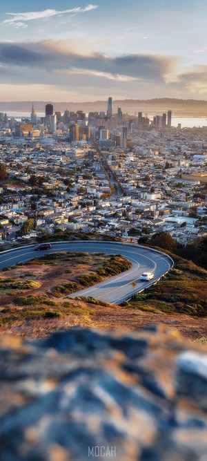 San Francisco cityscape with winding road and cars
