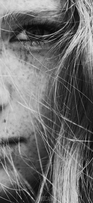 black and white close up shot of young female face with freckles in ...
