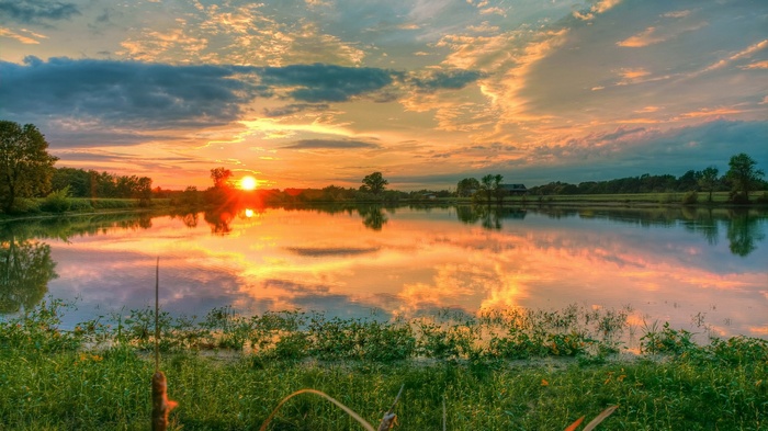 Sunset over a calm lake with reflections