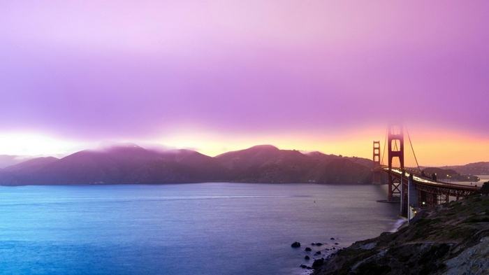 Golden Gate Bridge at sunset with purple sky