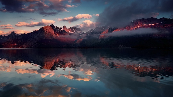 Mountain range reflected in a lake at sunset