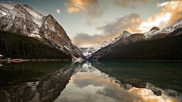 Lake Louise with snow-capped mountains and forest