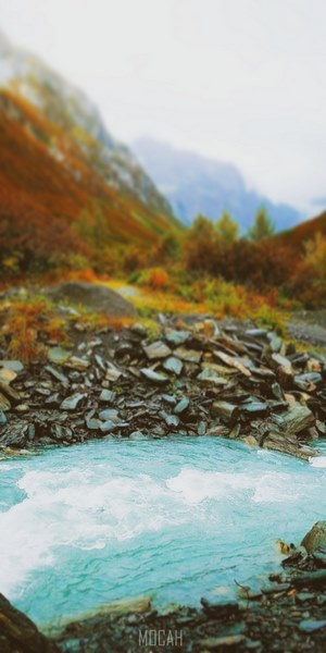 Turquoise River Flowing Through Rocky Terrain With Autumn Mountains Hd ...