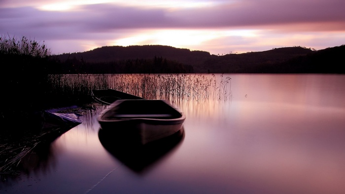 Boats on a lake at sunset