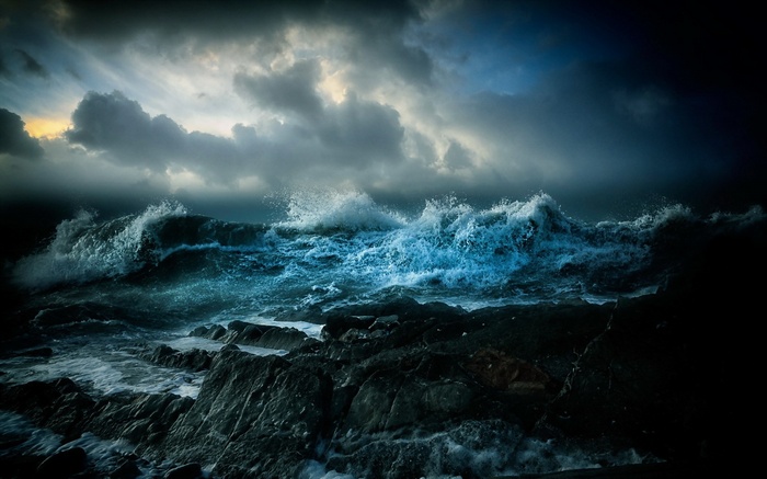 Stormy ocean waves crashing on rocky shore