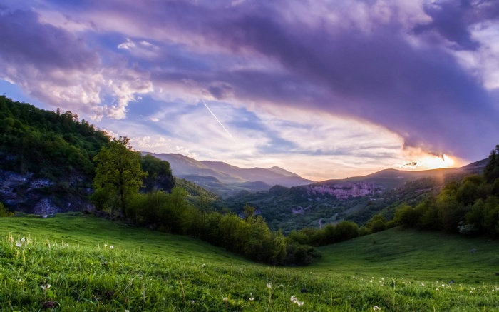 Mountain valley with dramatic sunset clouds