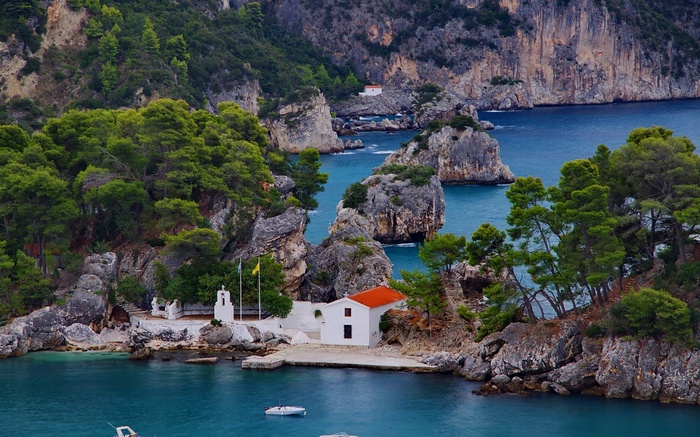 White churches on rocky islands in a blue bay