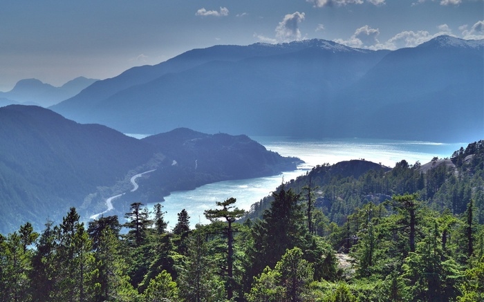 Mountainous landscape with a winding road and a lake