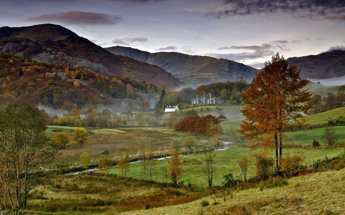 Autumn landscape with mountains and a house
