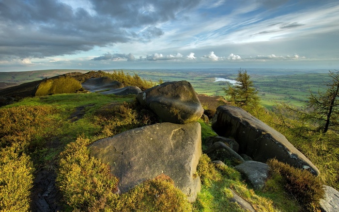 Rocky outcrop overlooking a valley with a river