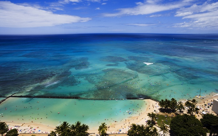 Aerial view of a crowded beach and turquoise ocean