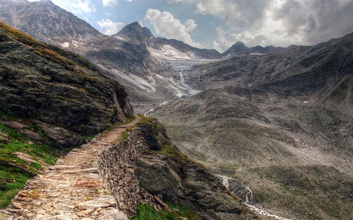 Stone path along a mountain with a glacier