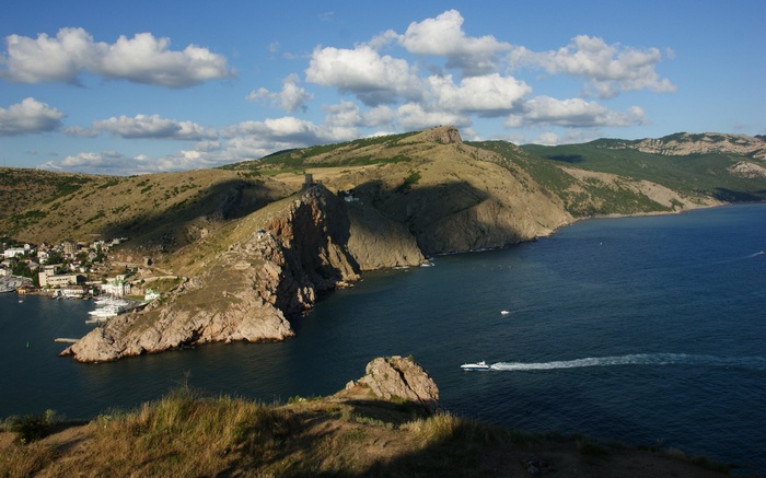 Coastal town with rocky cliffs and blue sea