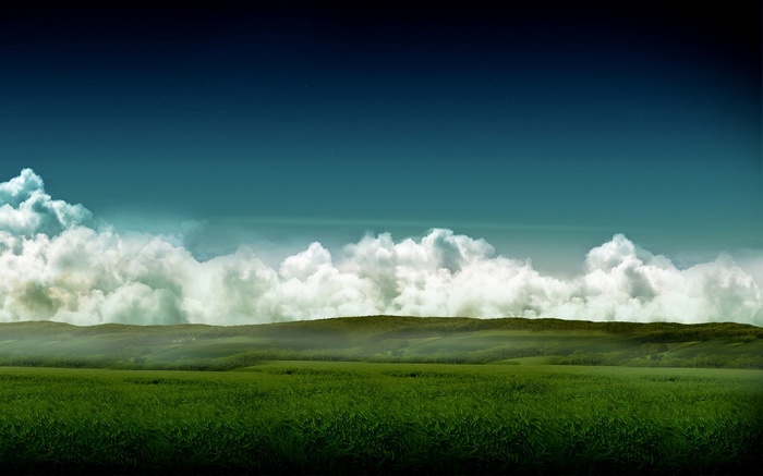 Green fields and rolling hills under a cloudy sky
