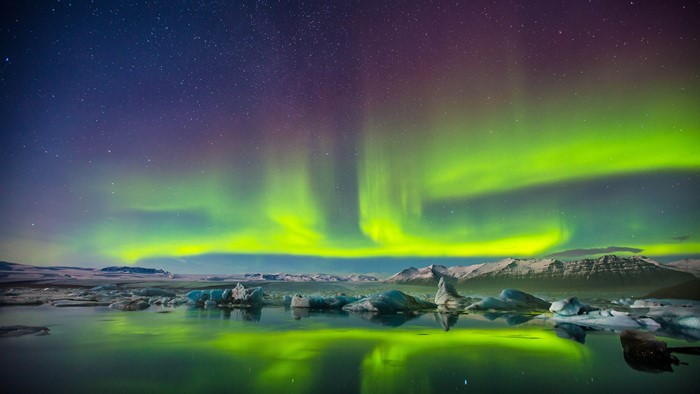 Aurora Borealis over icy landscape at night