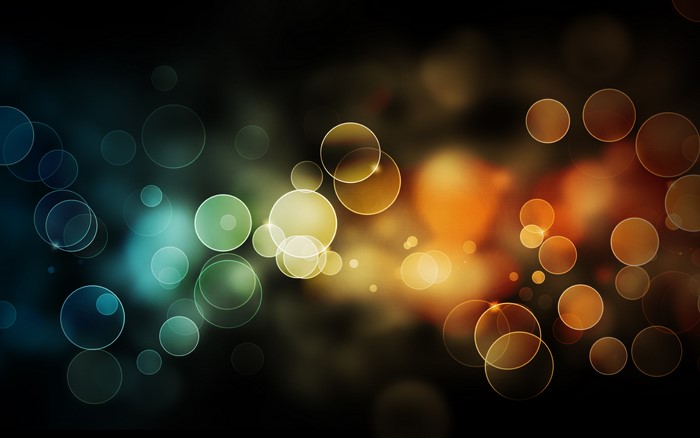 Abstract bokeh circles with blue, green, yellow, and orange colors