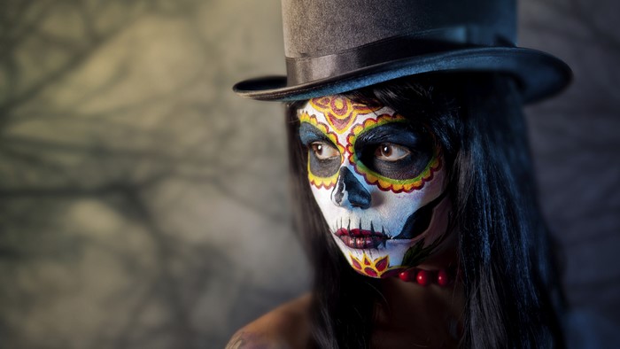 Woman with Day of the Dead face paint and top hat
