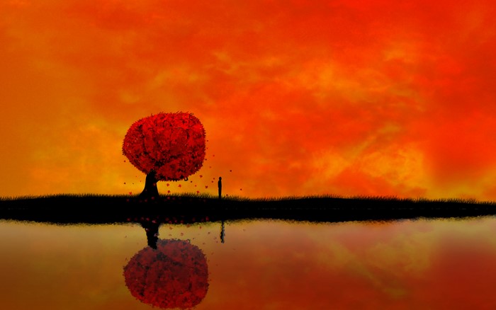 Silhouette of a person and a tree by a lake