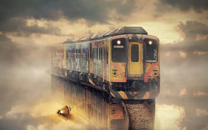 Train reflected in water with clouds