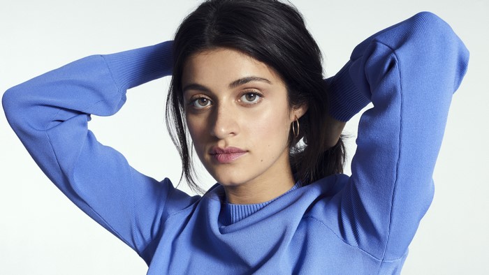 Anya Chalotra wearing a blue sweater
