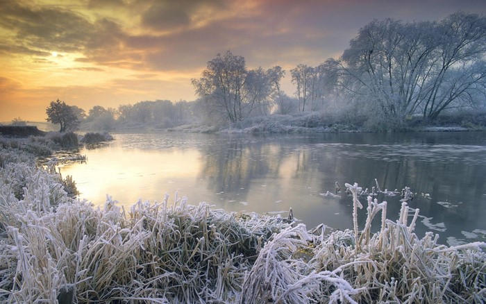 Winter sunrise over a frozen lake in England
