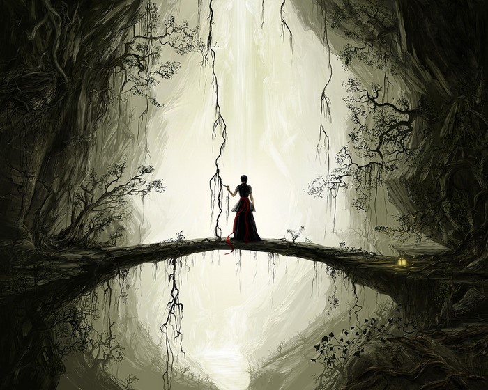 Woman in a red and black dress on a bridge in a cave