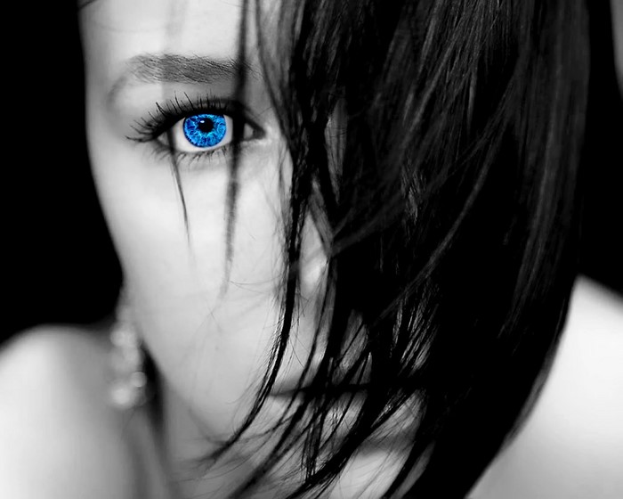 Close-up of a woman's face with blue eye