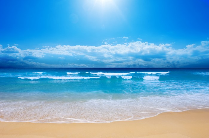 Beach with Ocean Waves and Blue Sky